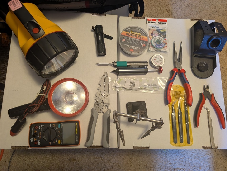 An assortment of hand tools and soldering gear