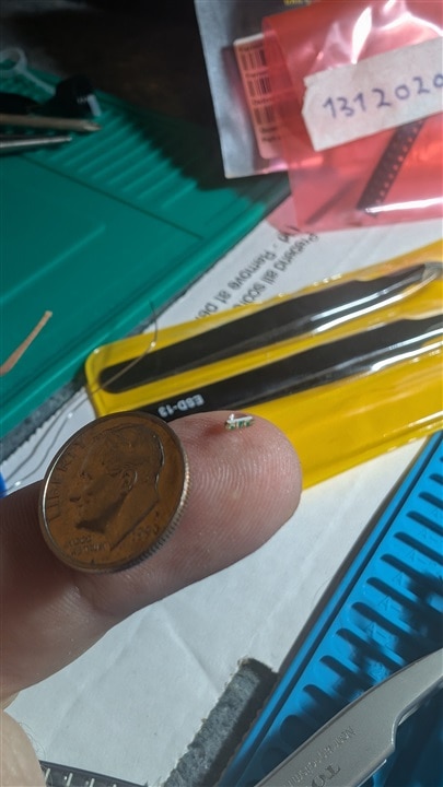 LED on finger with dime for scale