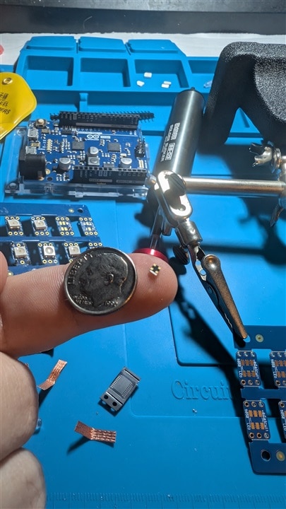 LED on finger with dime for scale