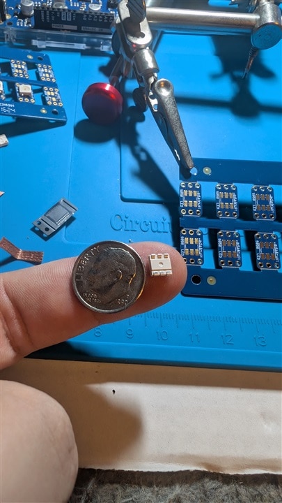 LED on finger with dime for scale