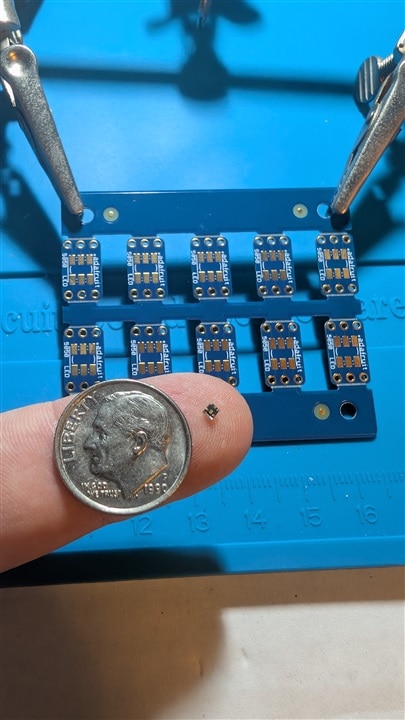 LED on finger with dime for scale