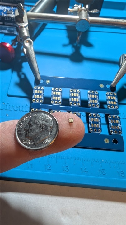 LED on finger with dime for scale